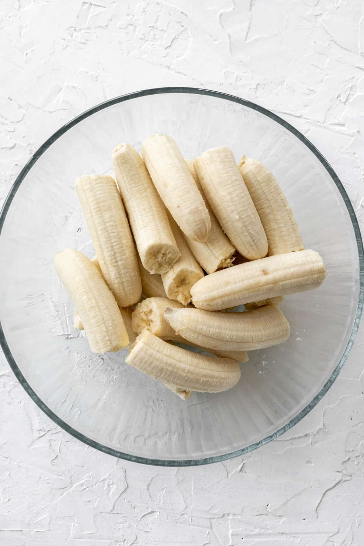 Peeled bananas in a glass bowl.
