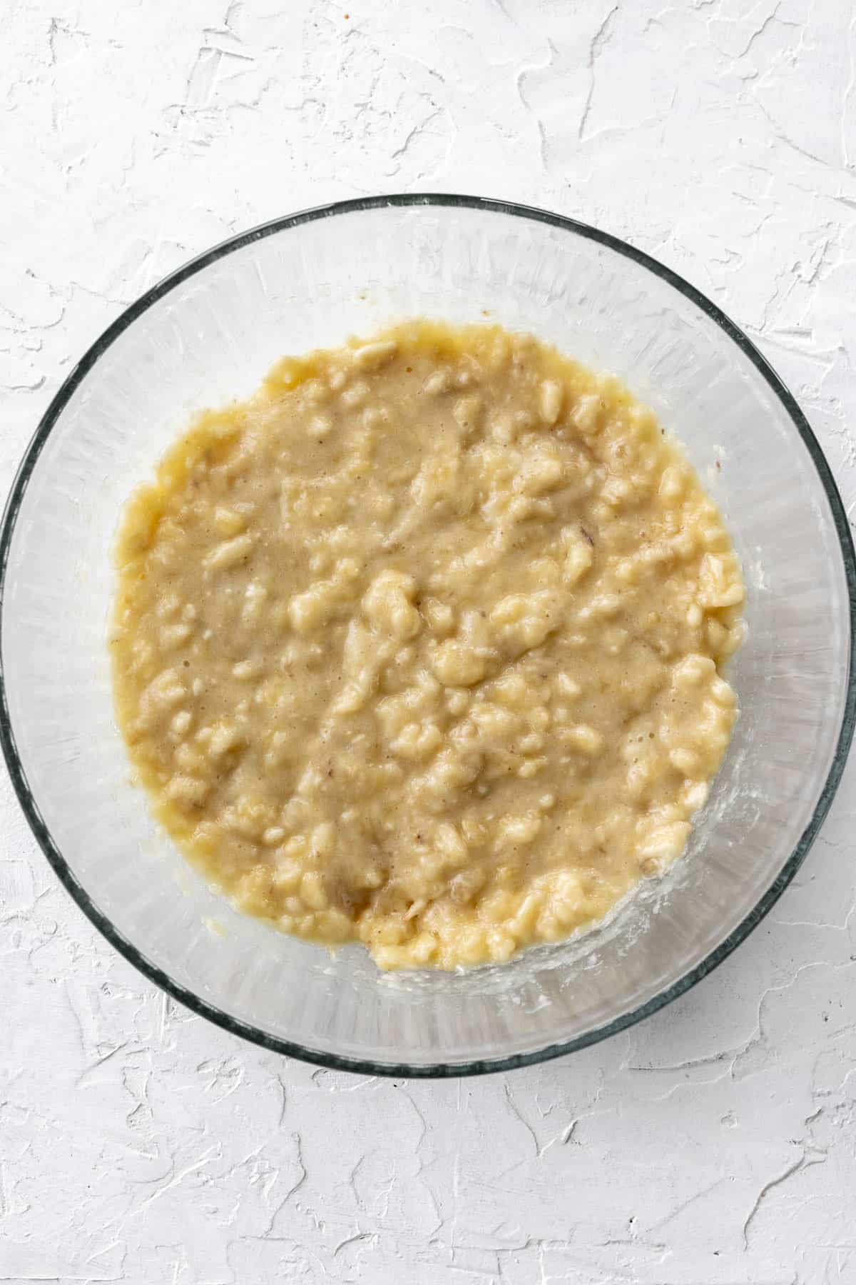 Mashed bananas in a glass bowl.