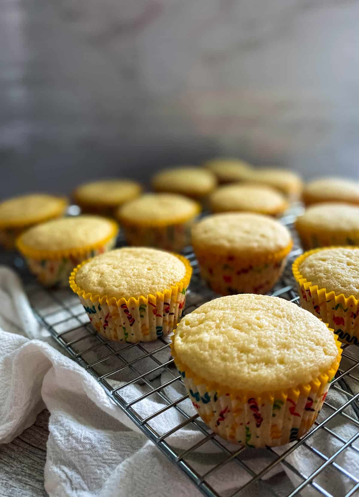 almond cupcakes on a cooling rack