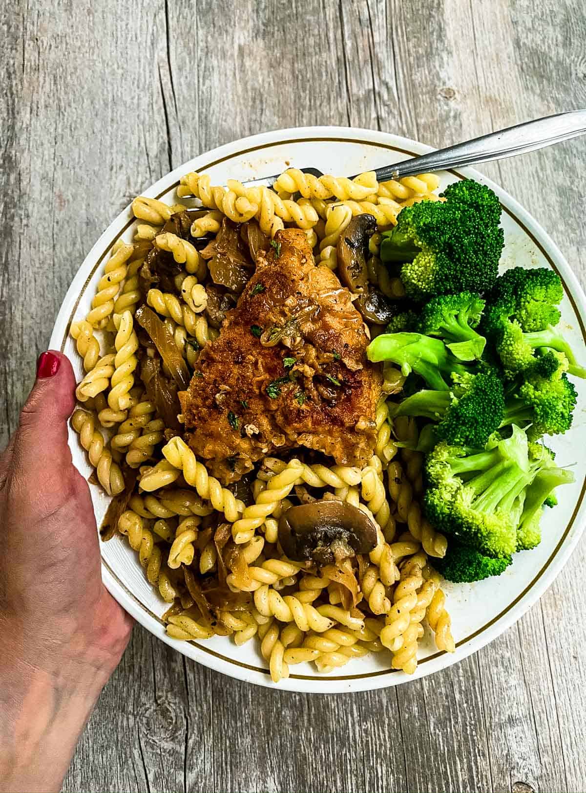 chicken marsala on plate with pasta and broccoli