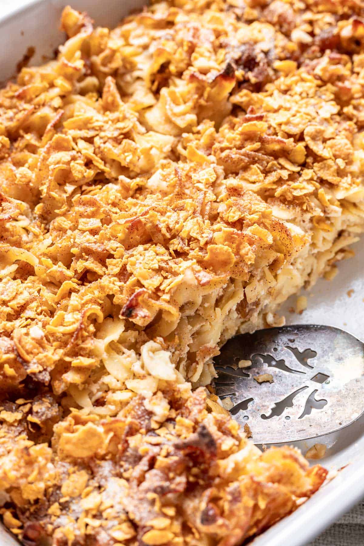 Cinnamon apple noodle kugel topped with crushed corn flakes and cinnamon sugar.