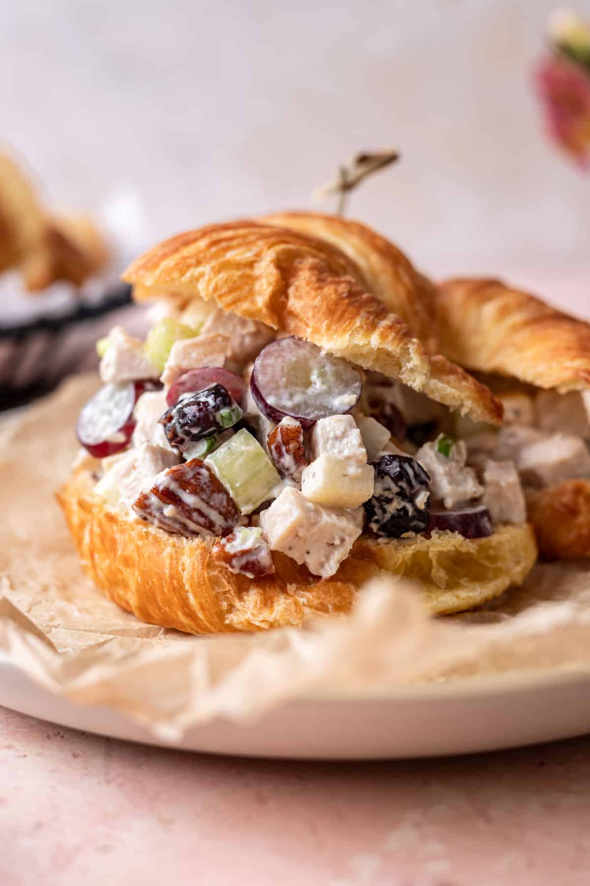 Cranberry pecan chicken salad assembled on a croissant sandwich.