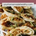 Pinterest pin for chinese chicken dumplings with sesame soy sauce.