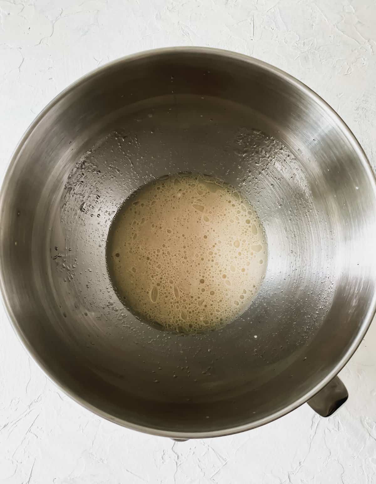 frothy yeast, beer, and water mixture in a mixing bowl