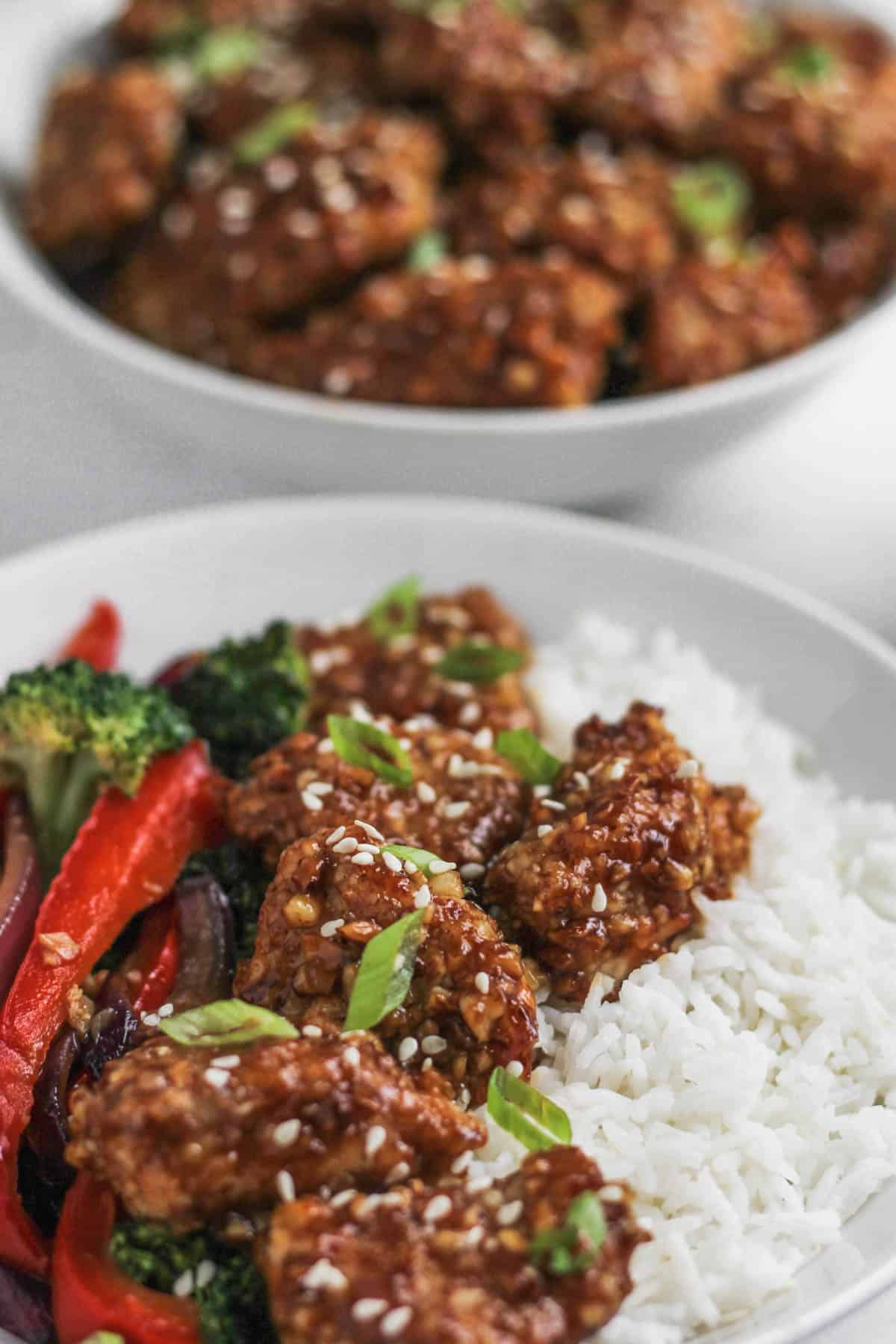 Close up view of almond chicken in honey soy sauce.