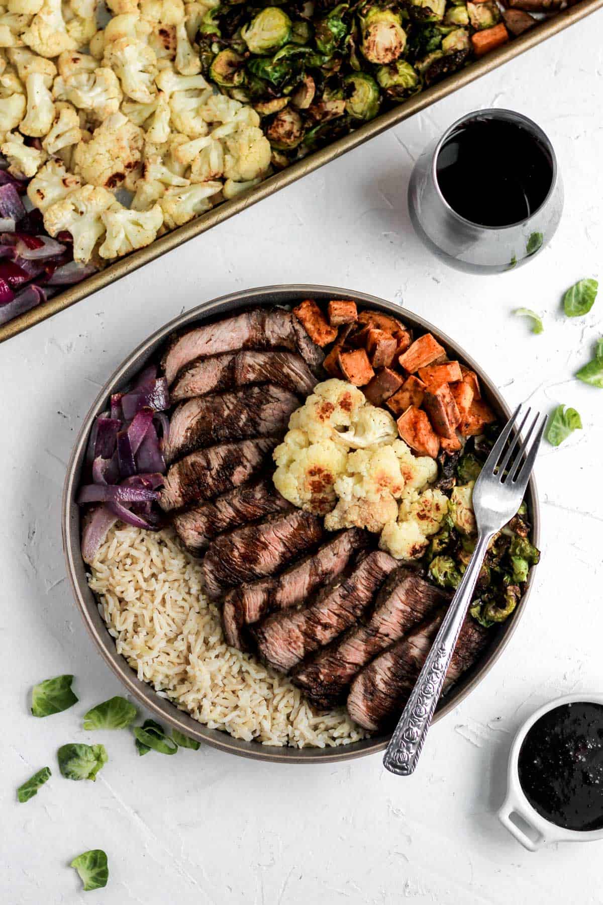 Glazed balsamic steak and veggie bowls with red wine and balsamic glaze in a white dish.