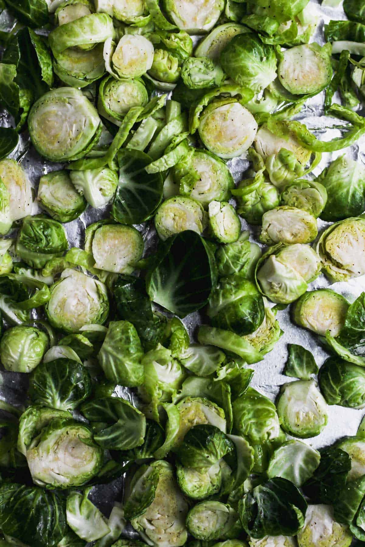 Sliced Brussels sprouts on a sheet pan.