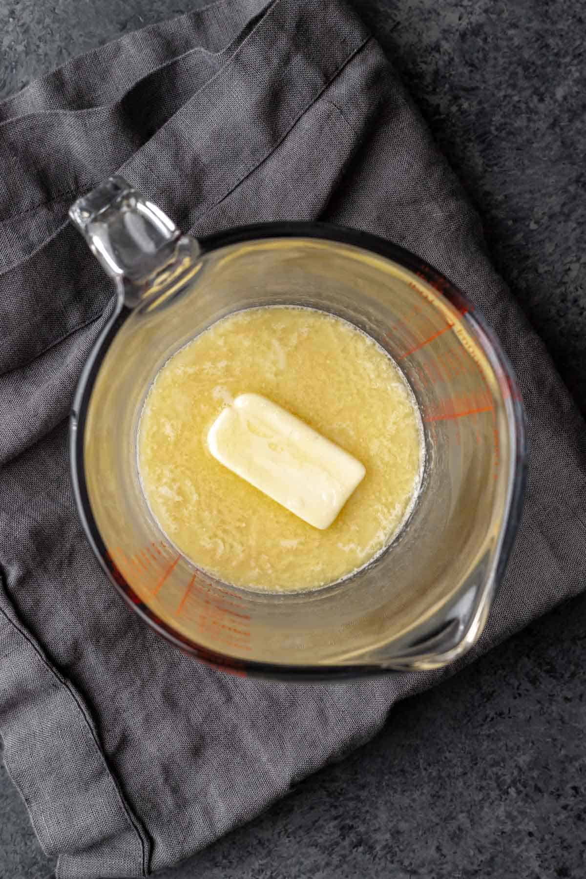 Butter melted with almond milk in a large liquid measuring cup.