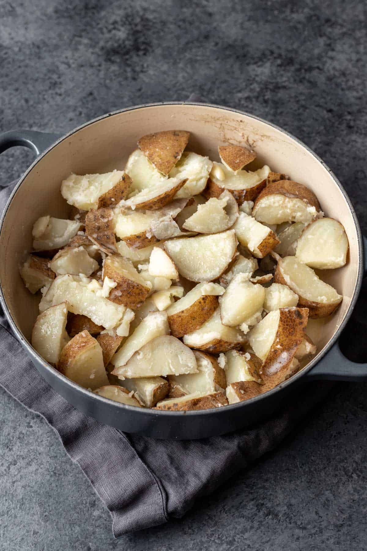 Boiled and drained potatoes and garlic in a large pot. 