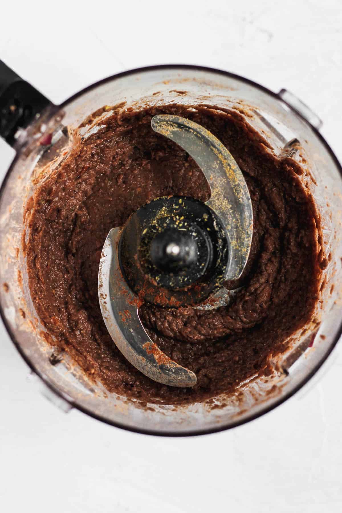 Blended black bean dip in a food processor.