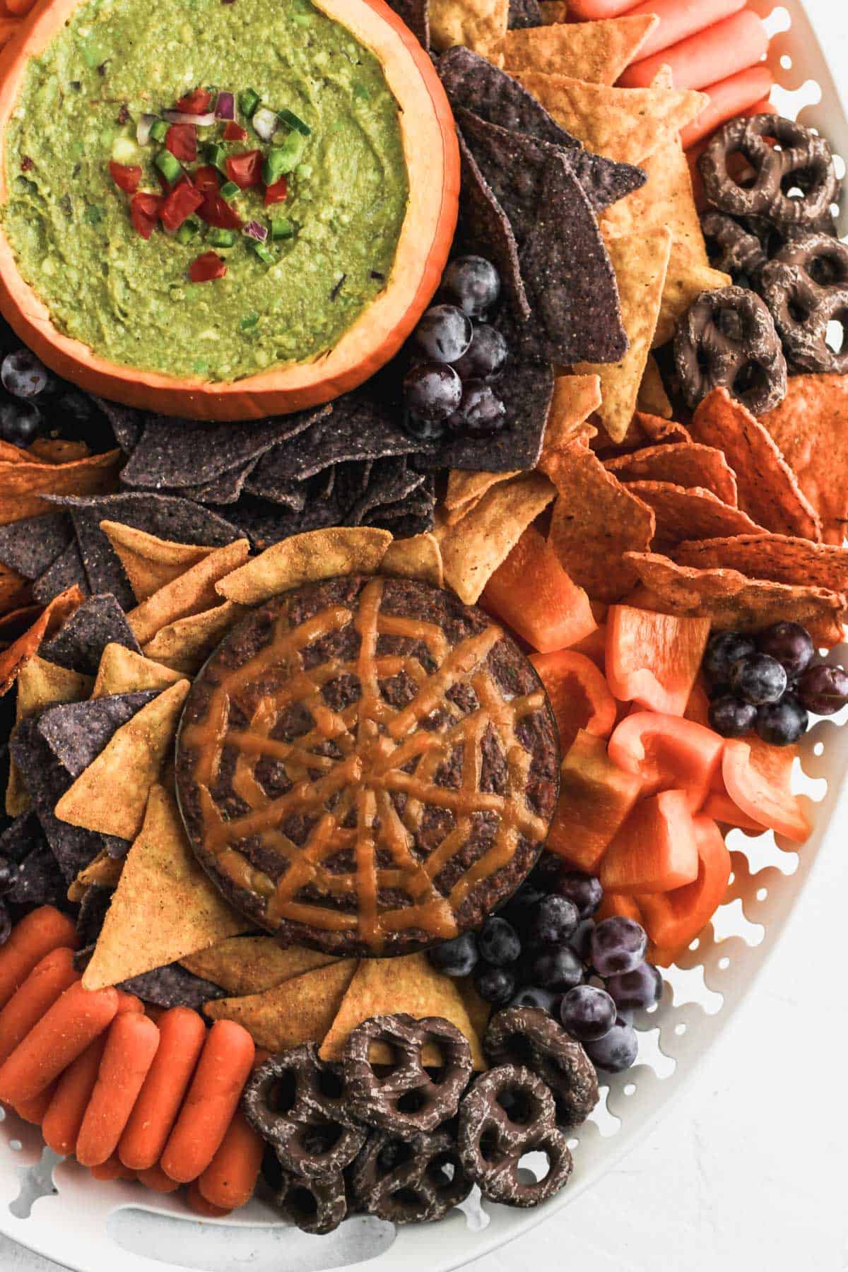 The bottom portion of the halloween snack board to show the spider web design on the black bean dip.