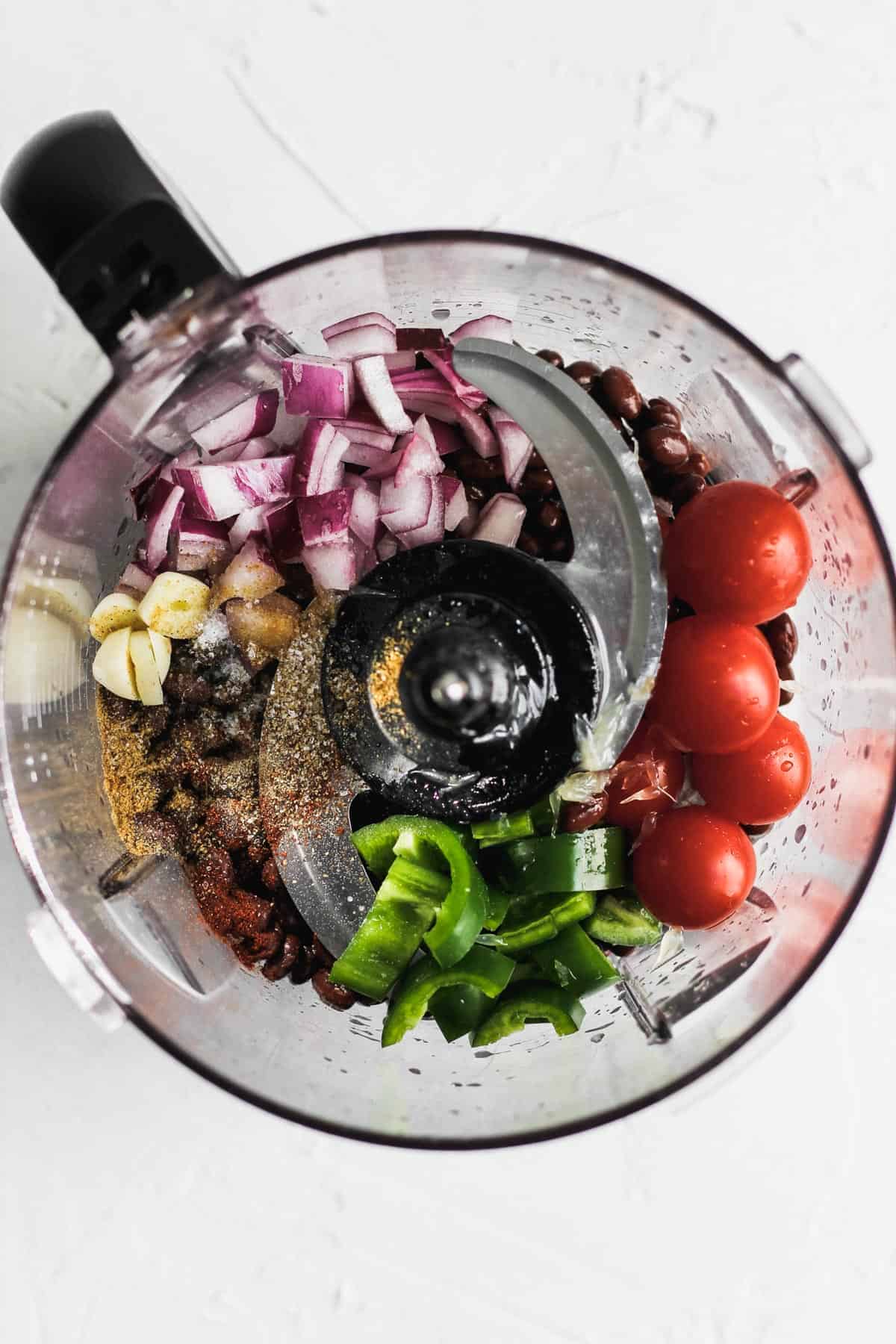 Ingredients for black bean dip in a food processor before blending.