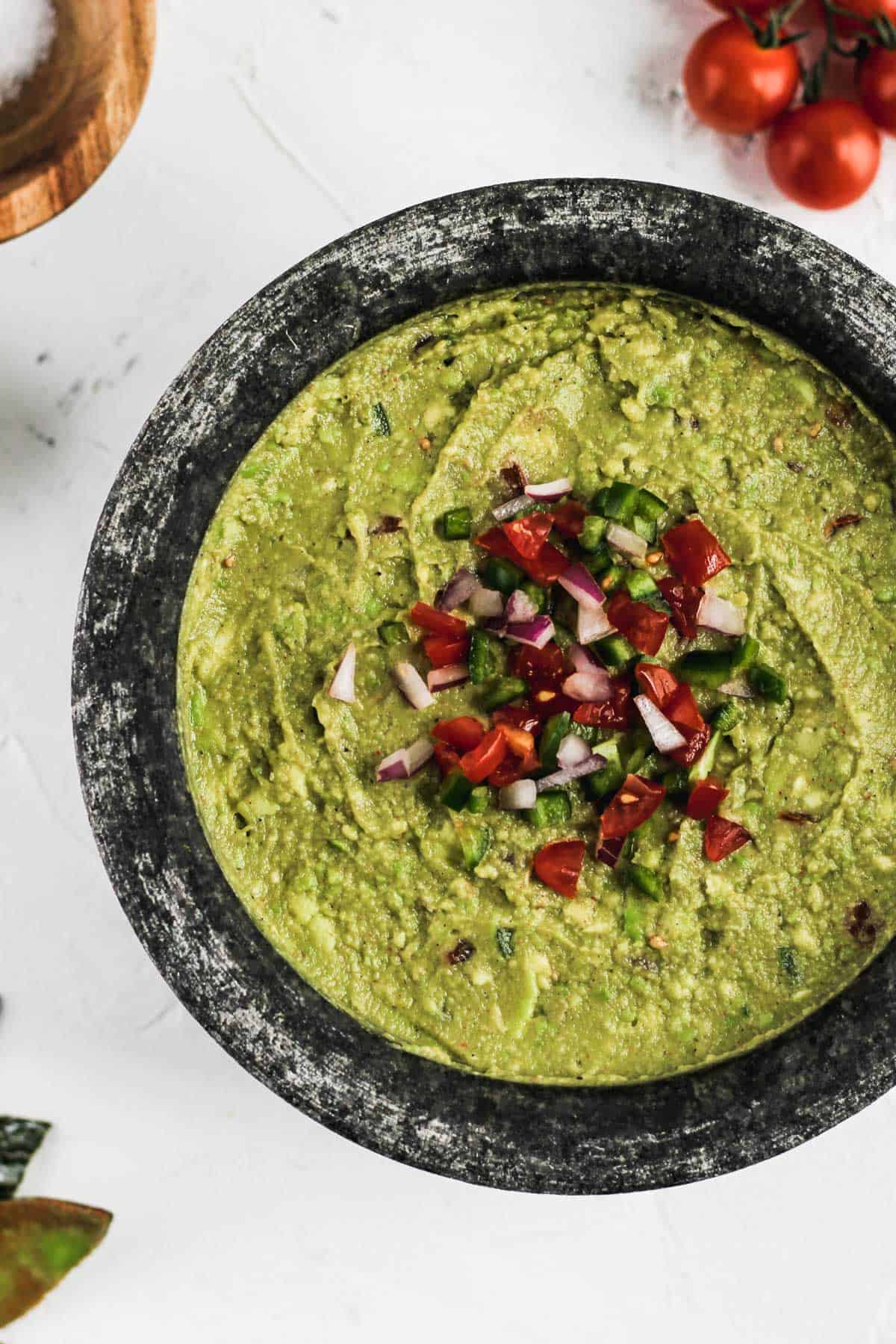 Finished homemade guacamole in a gray stone mortar.