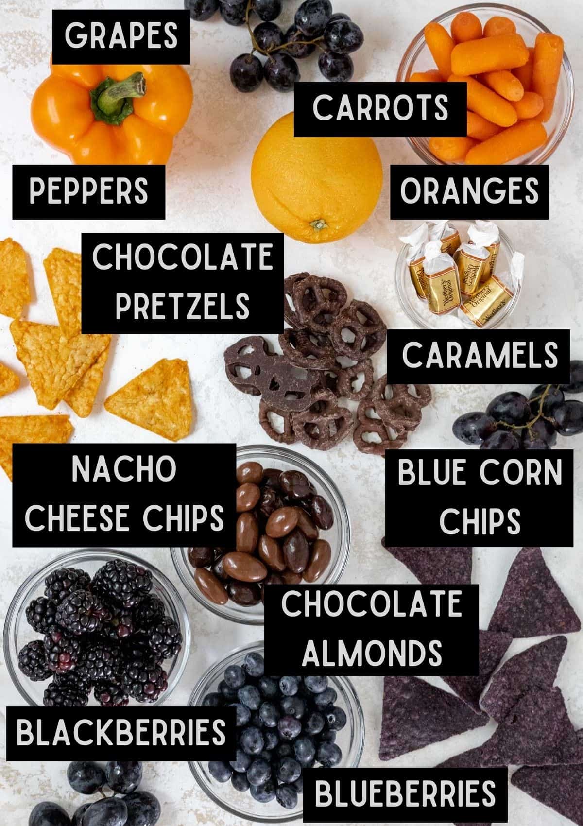 Labelled ingredients for a Halloween snack board (see recipe for details).