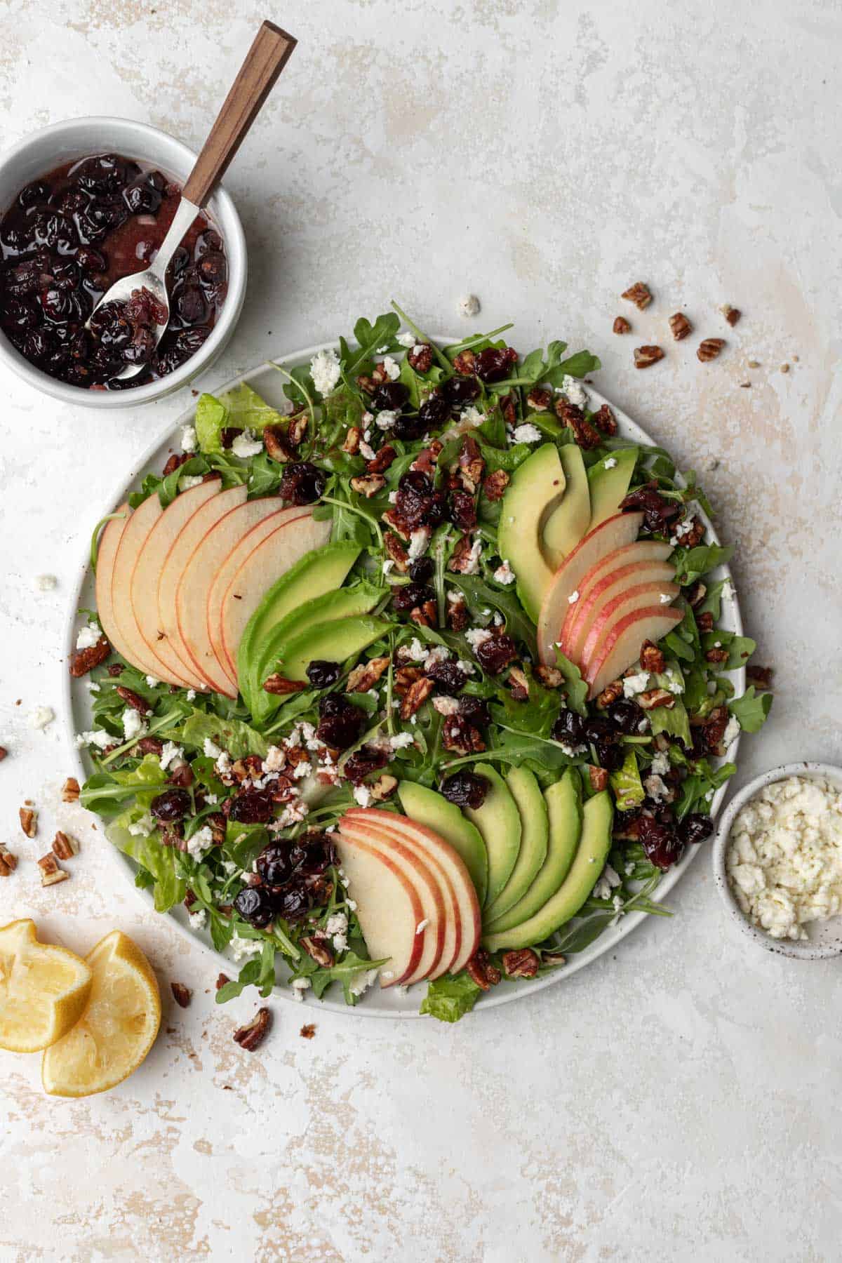 Apple, avocado, and arugula salad with sliced apples, avocado, feta, pecans, and freshly squeezed lemons.