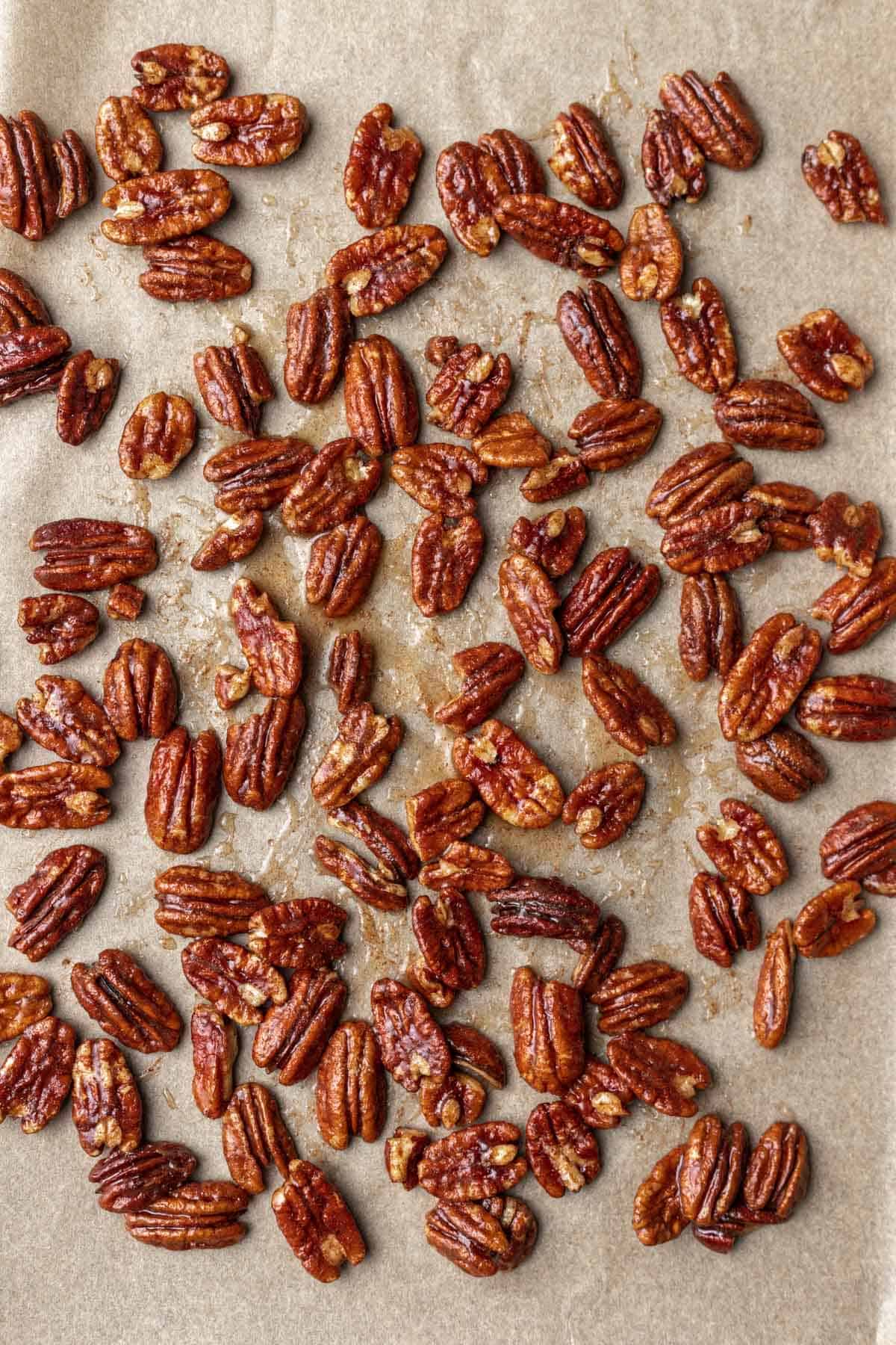 Maple cinnamon pecans on a sheet pan before toasting.