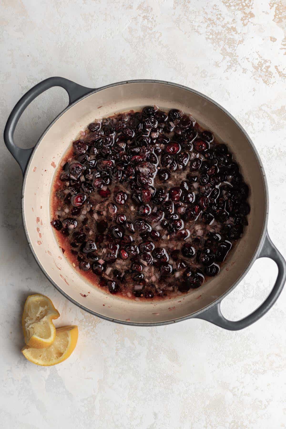 Cooked warm cranberry vinaigrette in a large pot with a splash of fresh lemon juice.