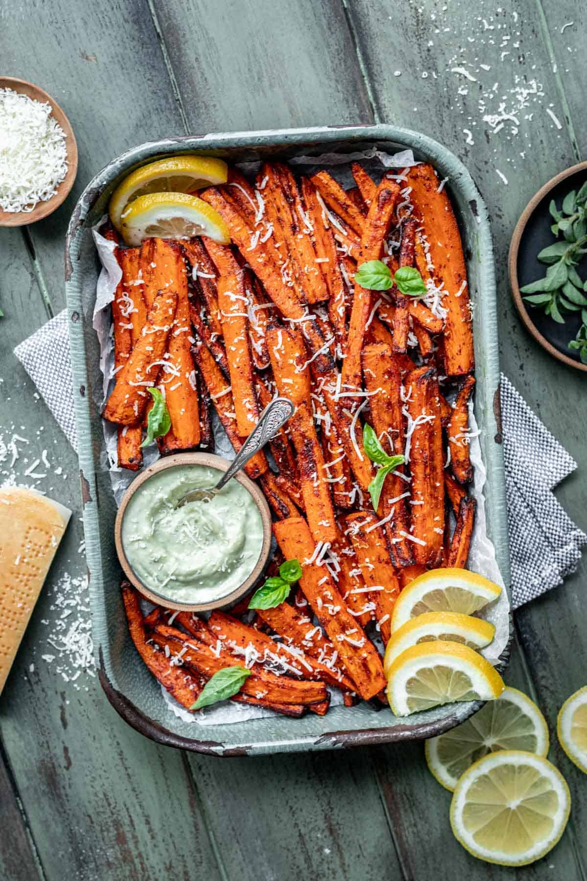 Air fryer carrot fries in a tray with a side of pesto aioli.