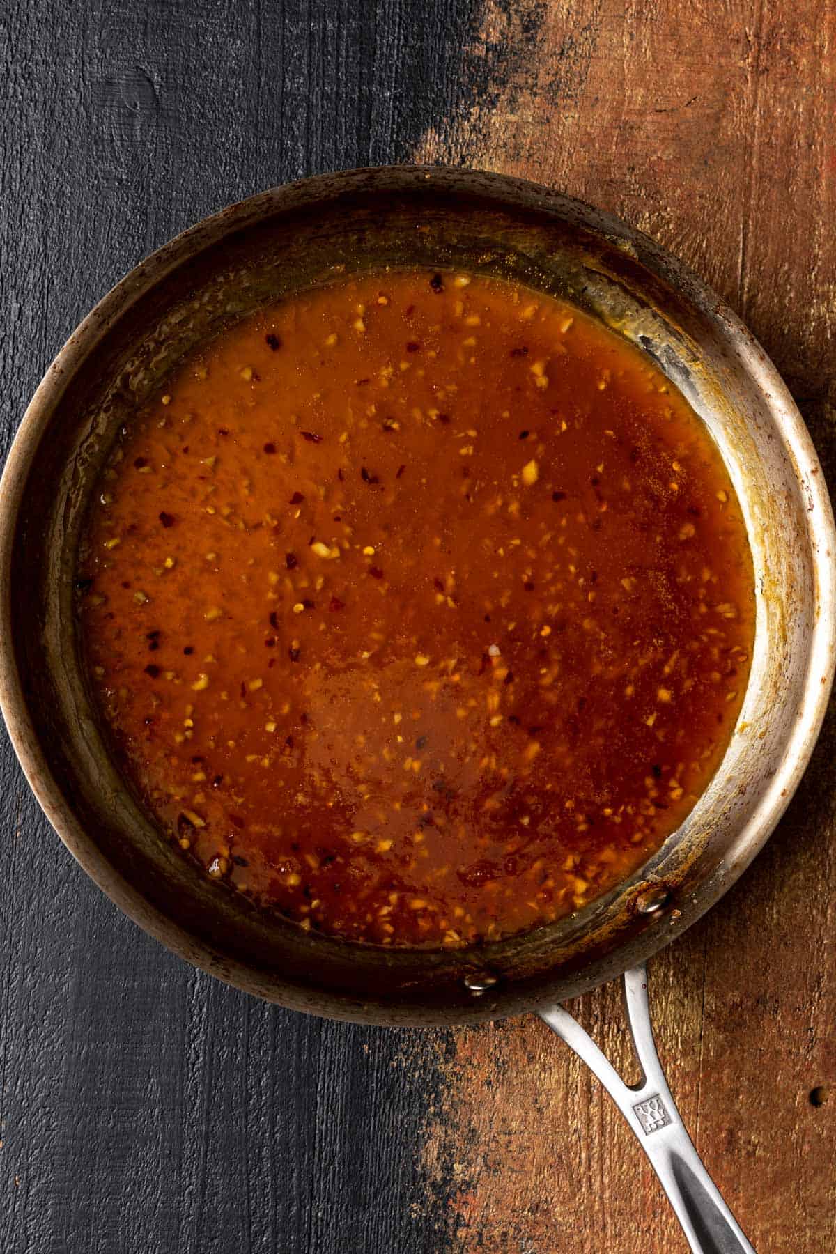 Thickened orange sauce in a skillet.