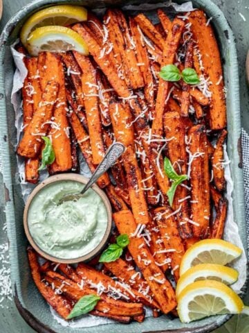 Air fryer carrot fries in a tray with a side of pesto aioli.