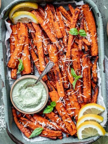 Air fryer carrot fries in a tray with a side of pesto aioli.