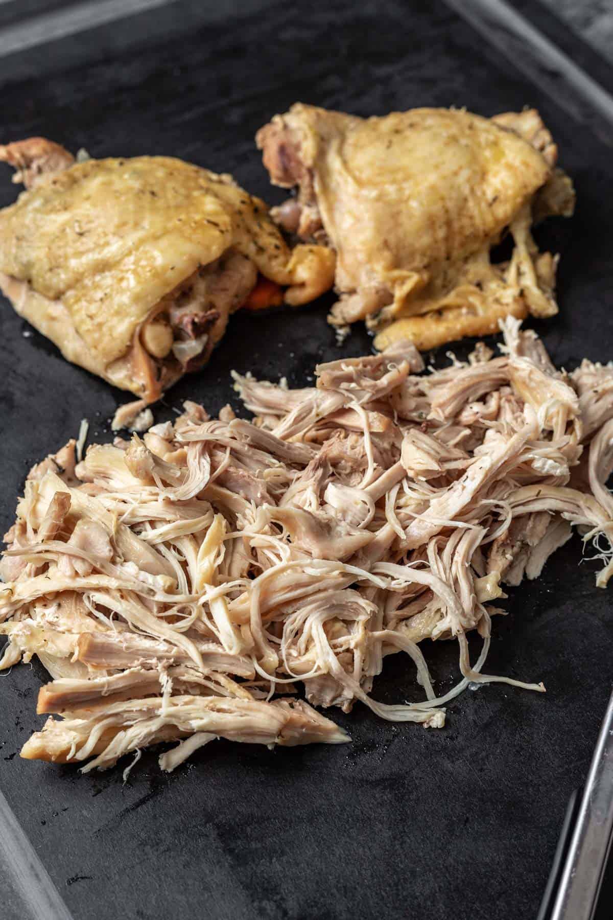 Shredded chicken on a cutting board.