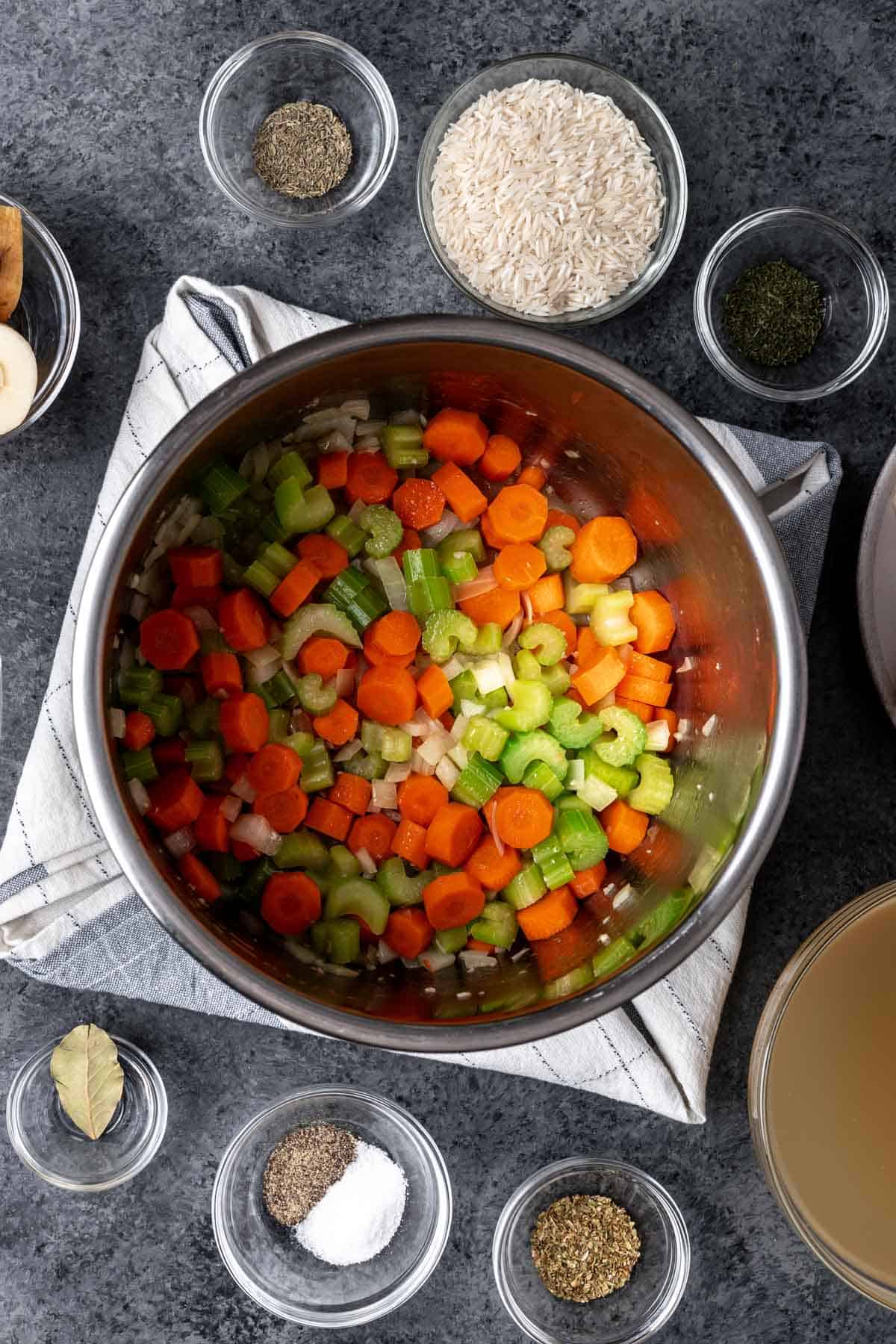 Onion, carrot, celery, and garlic cooking in an instant pot.