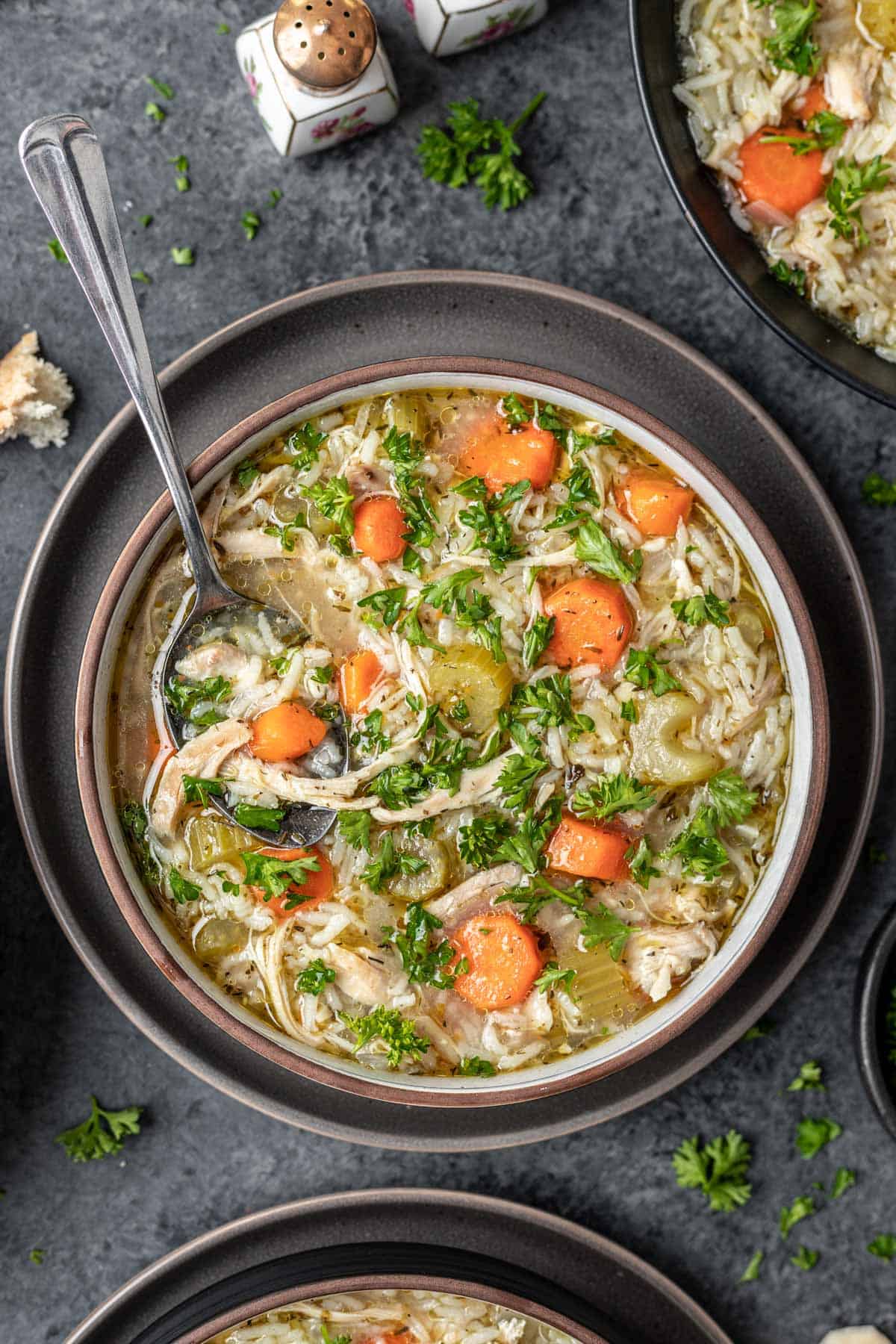 Instant pot chicken rice soup in a bowl with a spoon.