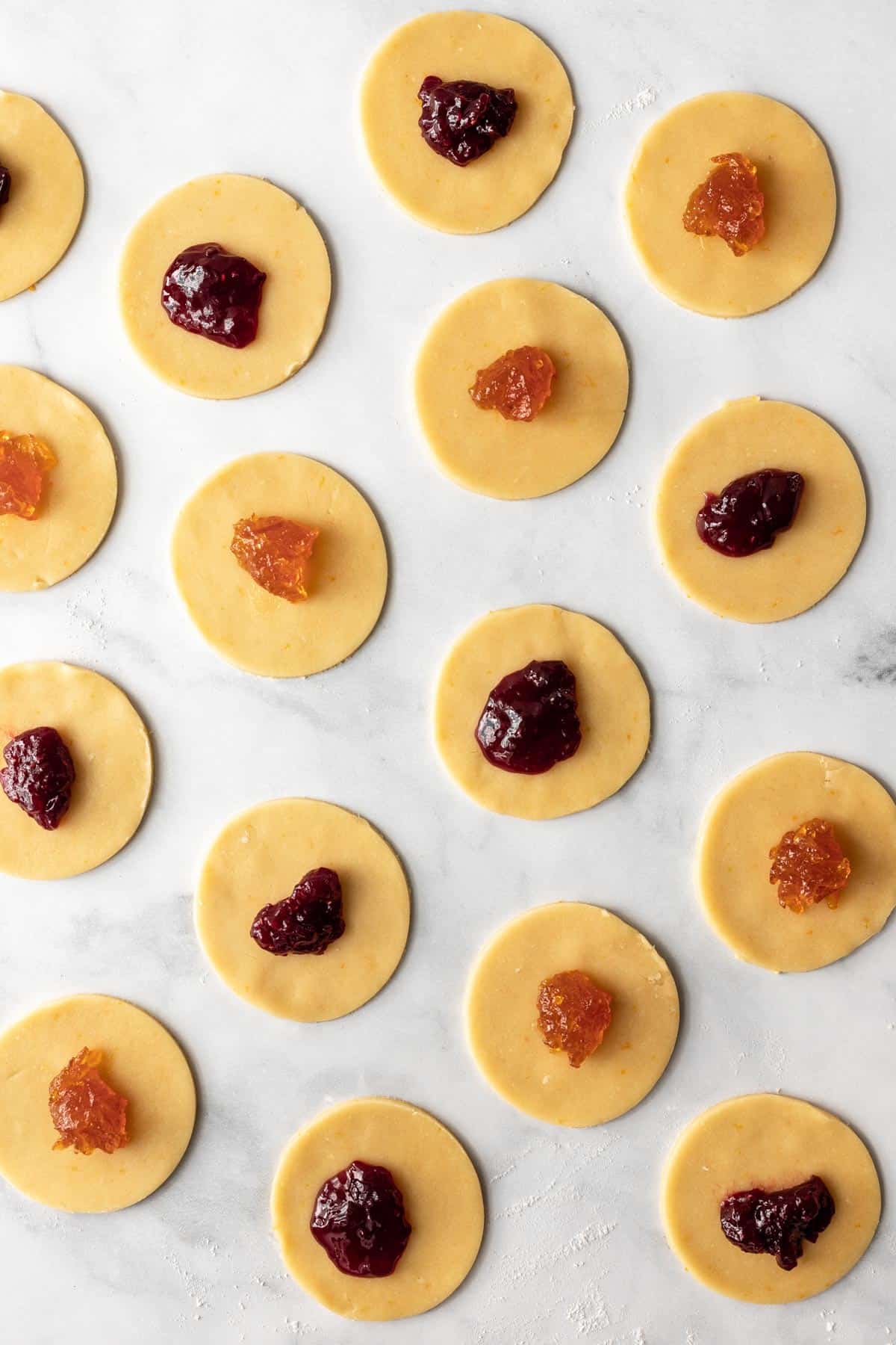 Jam scooped onto the center of circles of dough.