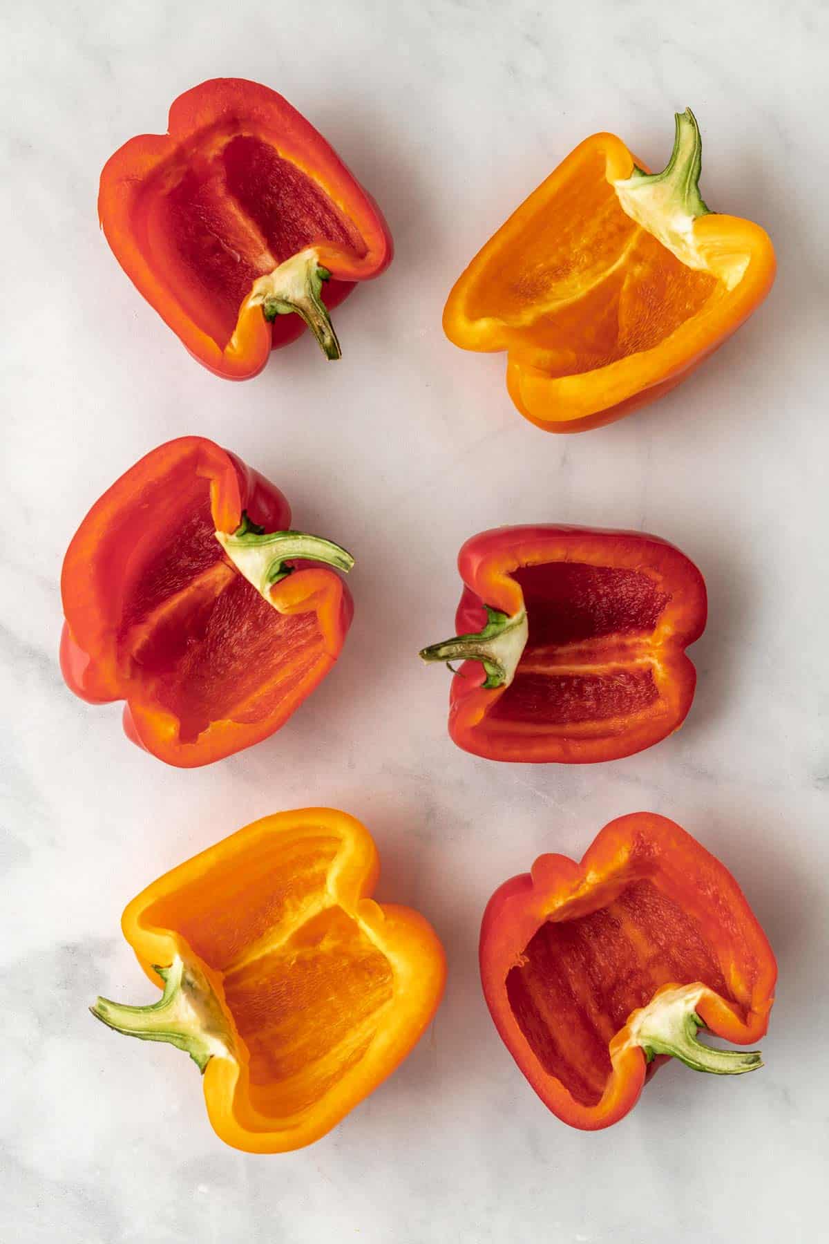 6 red and orange pepper halves with the seeds and ribs removed.