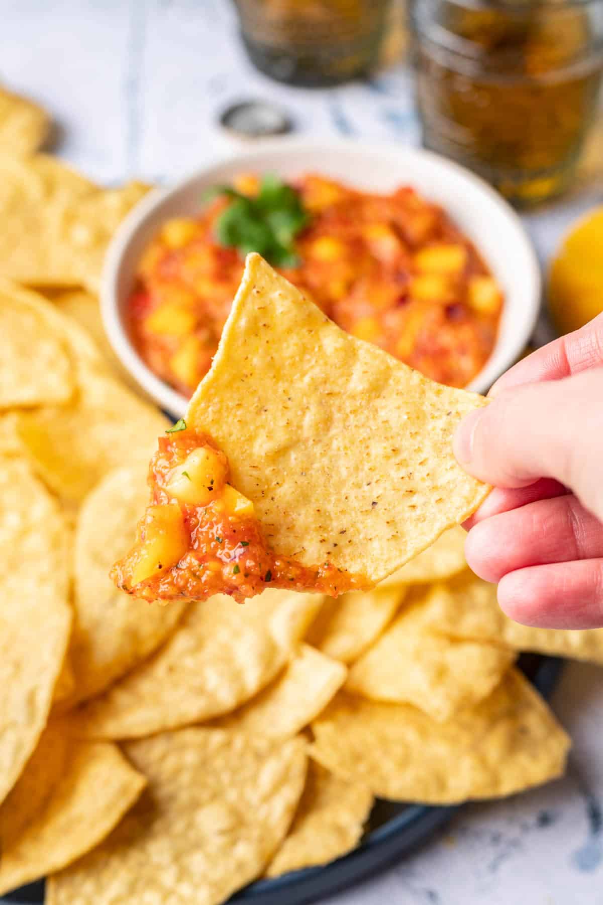 A chip scooping mango habanero salsa.