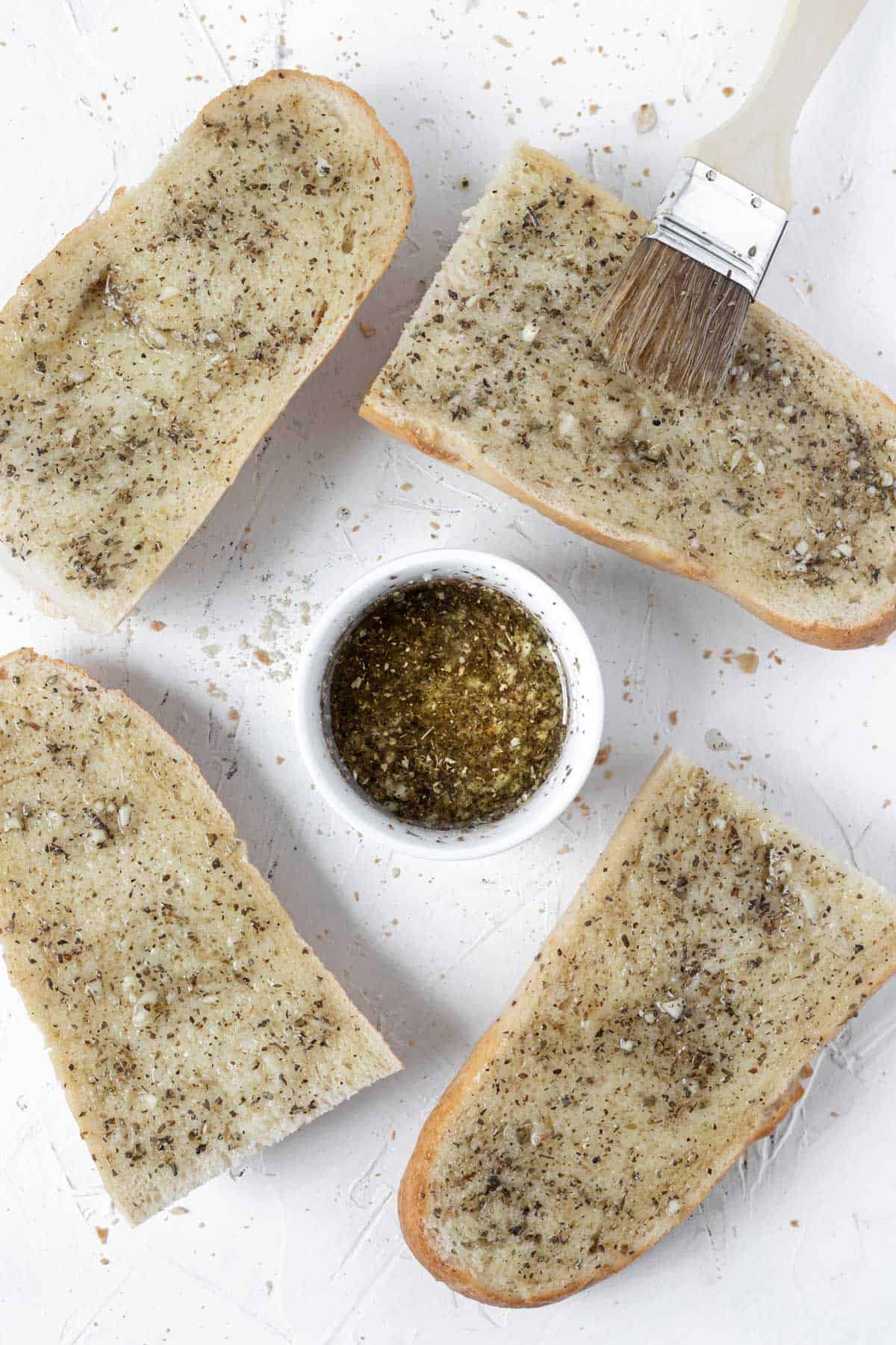 Garlic herb olive oil mixture brushed onto the 4 pieces of french bread.