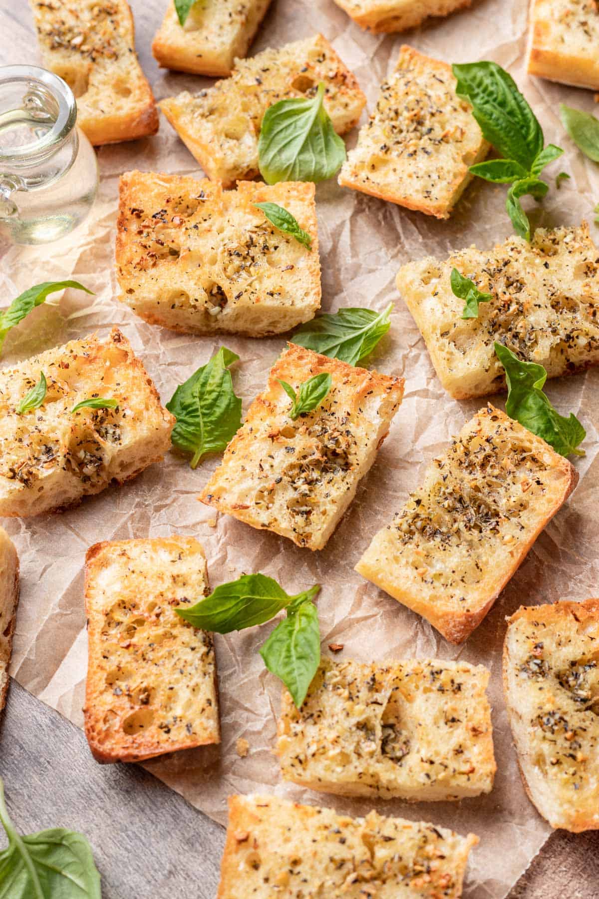 Sliced air fryer garlic bread arranged with fresh basil.