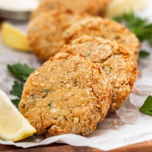 Air fryer chicken patties on a serving platter with lemon slices.