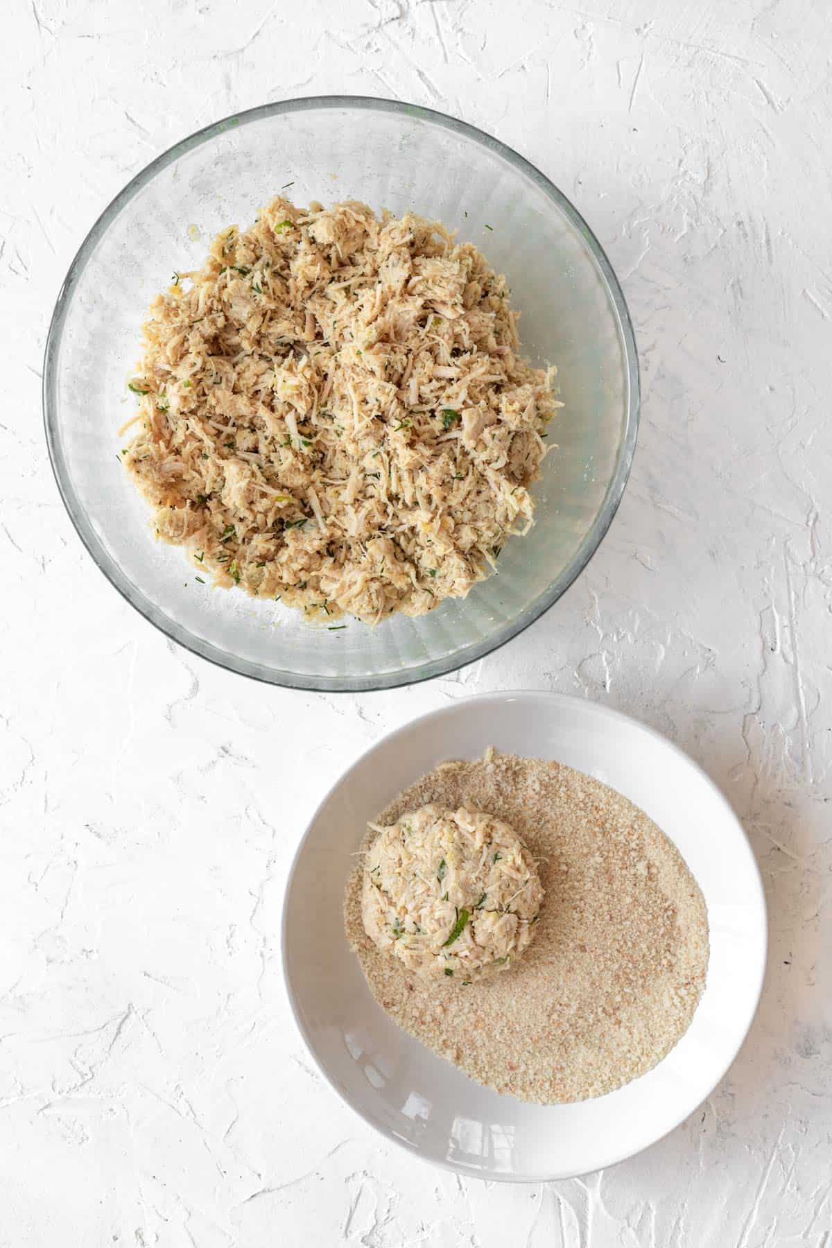 A formed chicken patty dipped in breadcrumbs.