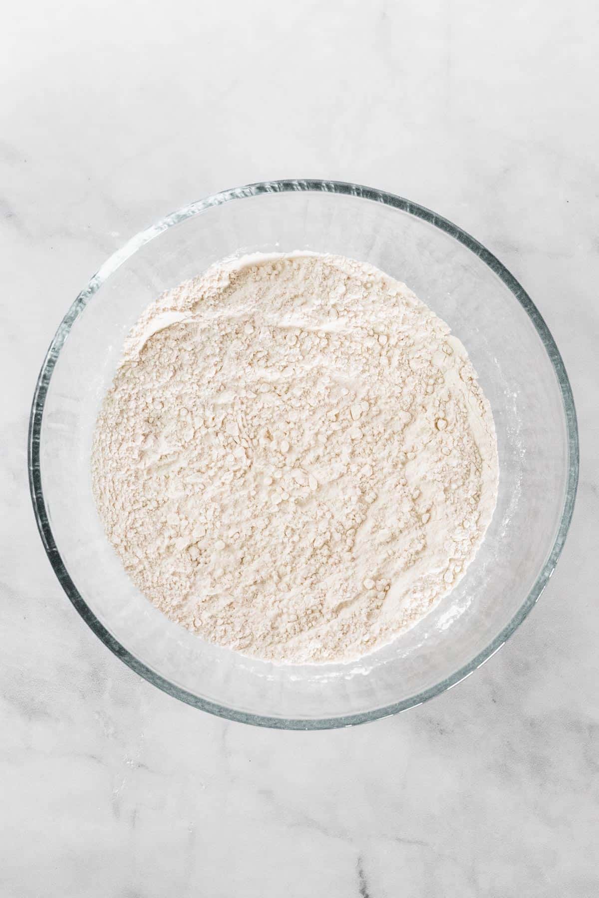 Dry ingredients mixed in a glass bowl.