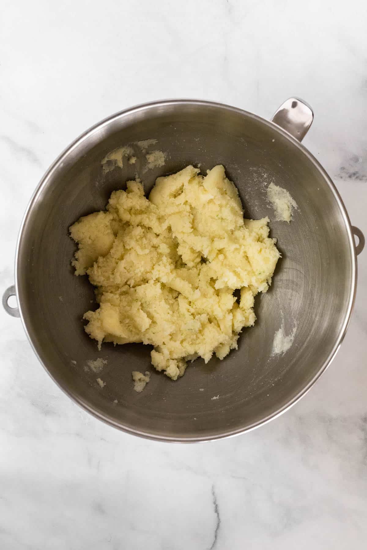 Butter, sugar, and lime zest whipped in a mixing bowl.