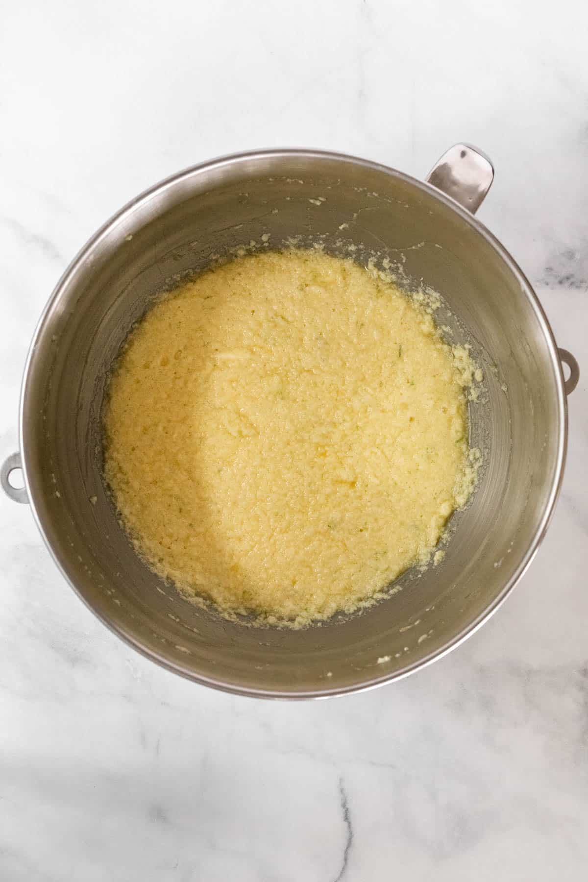 Wet ingredients combined in a metal mixing bowl.