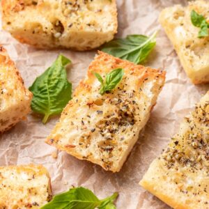 Golden brown air fryer garlic bread on parchment paper.