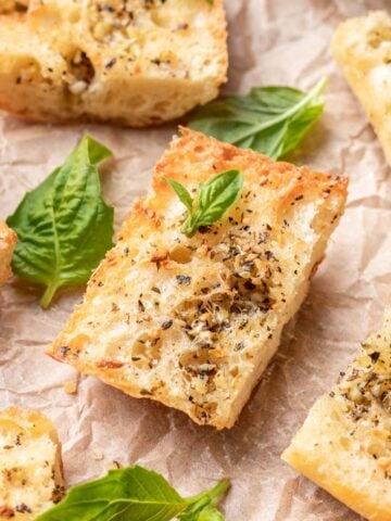 Golden brown air fryer garlic bread on parchment paper.