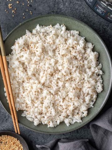 Instant pot sushi rice in a serving bowl with chopsticks.