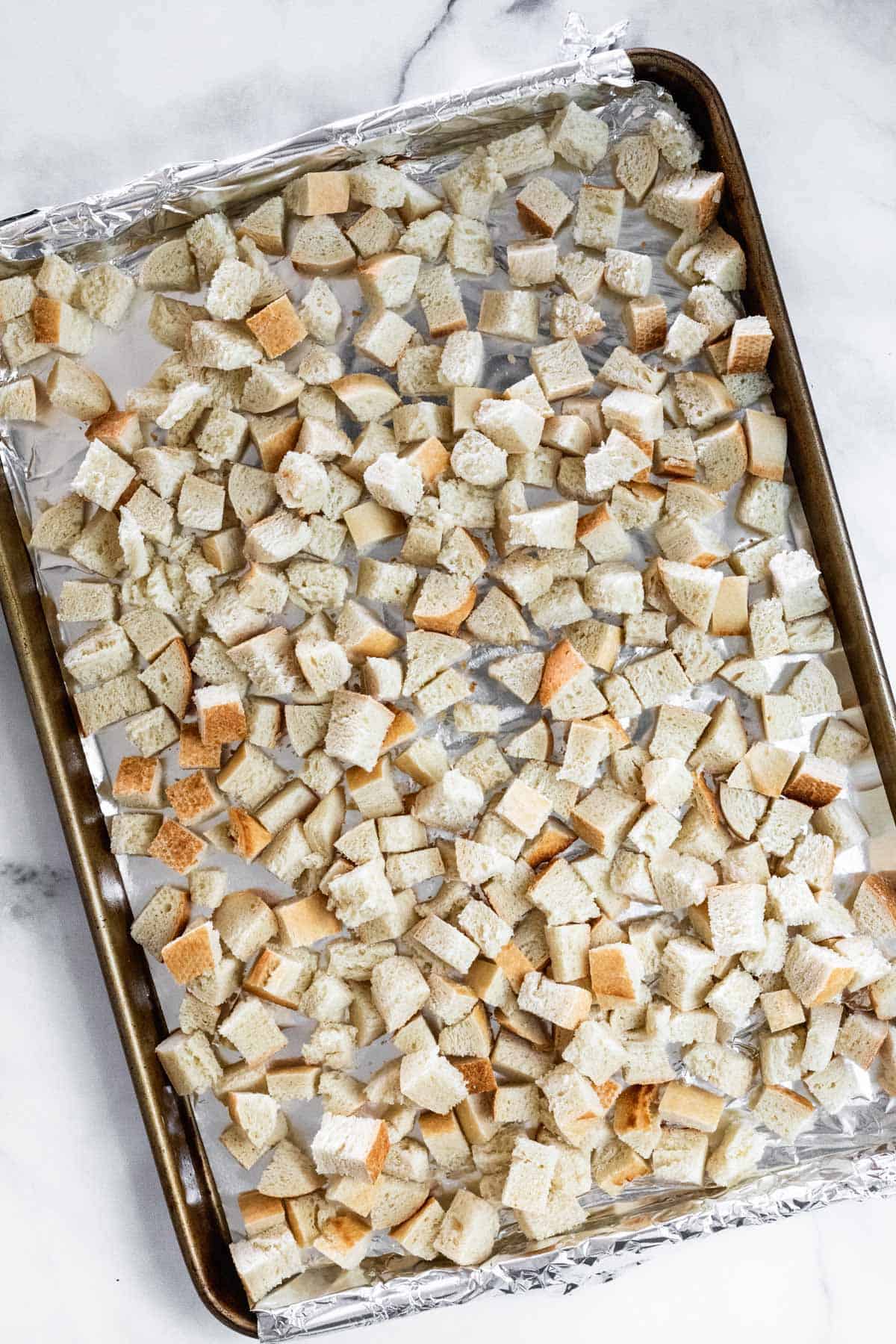 Diced baguette on a sheet pan.