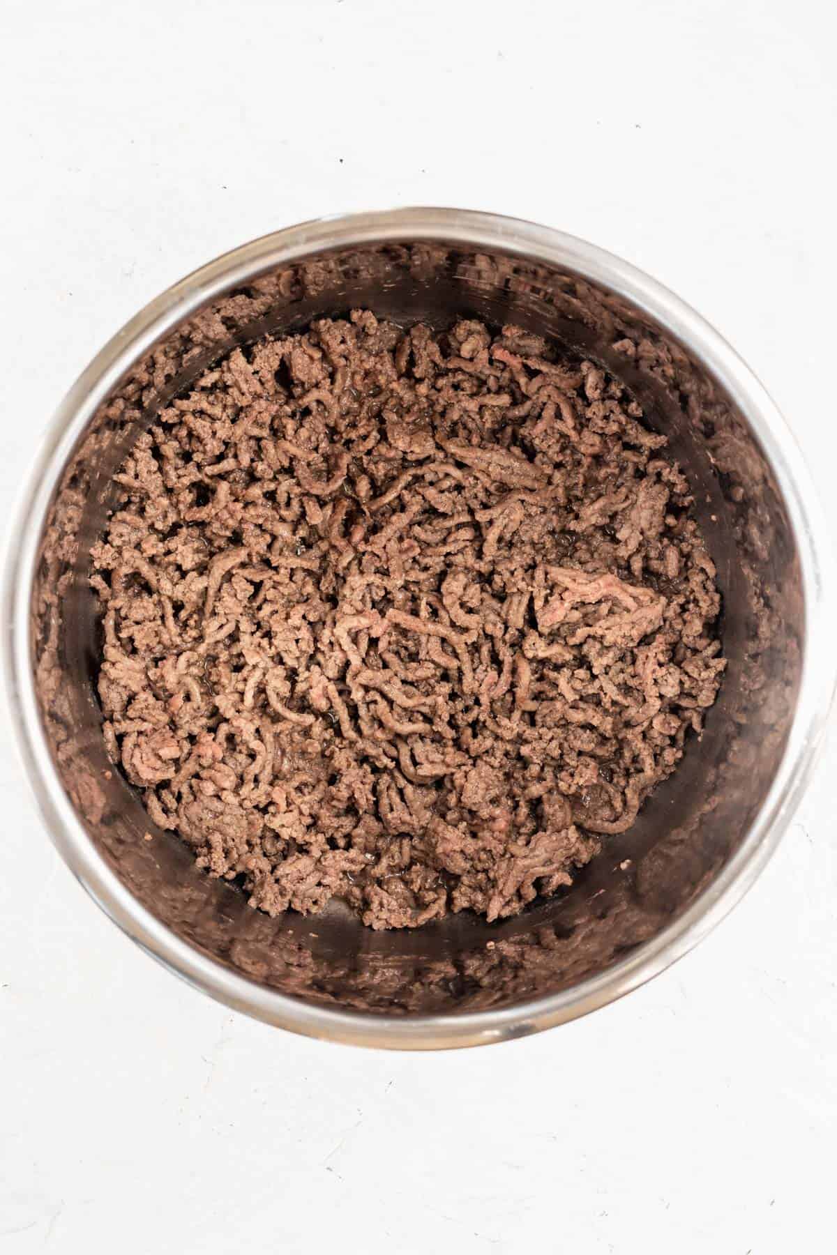 Cooked ground beef in the base of an instant pot.