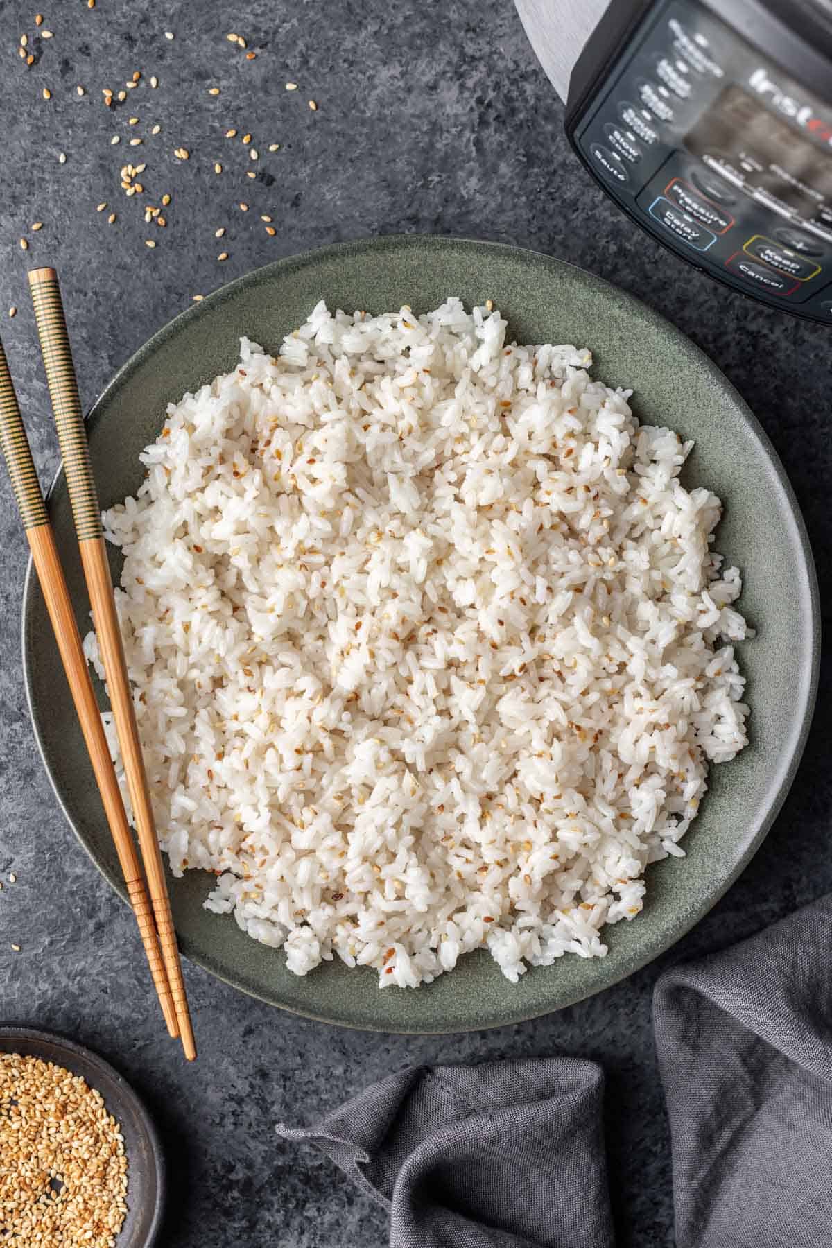 Instant pot sushi rice in a serving bowl with chopsticks.