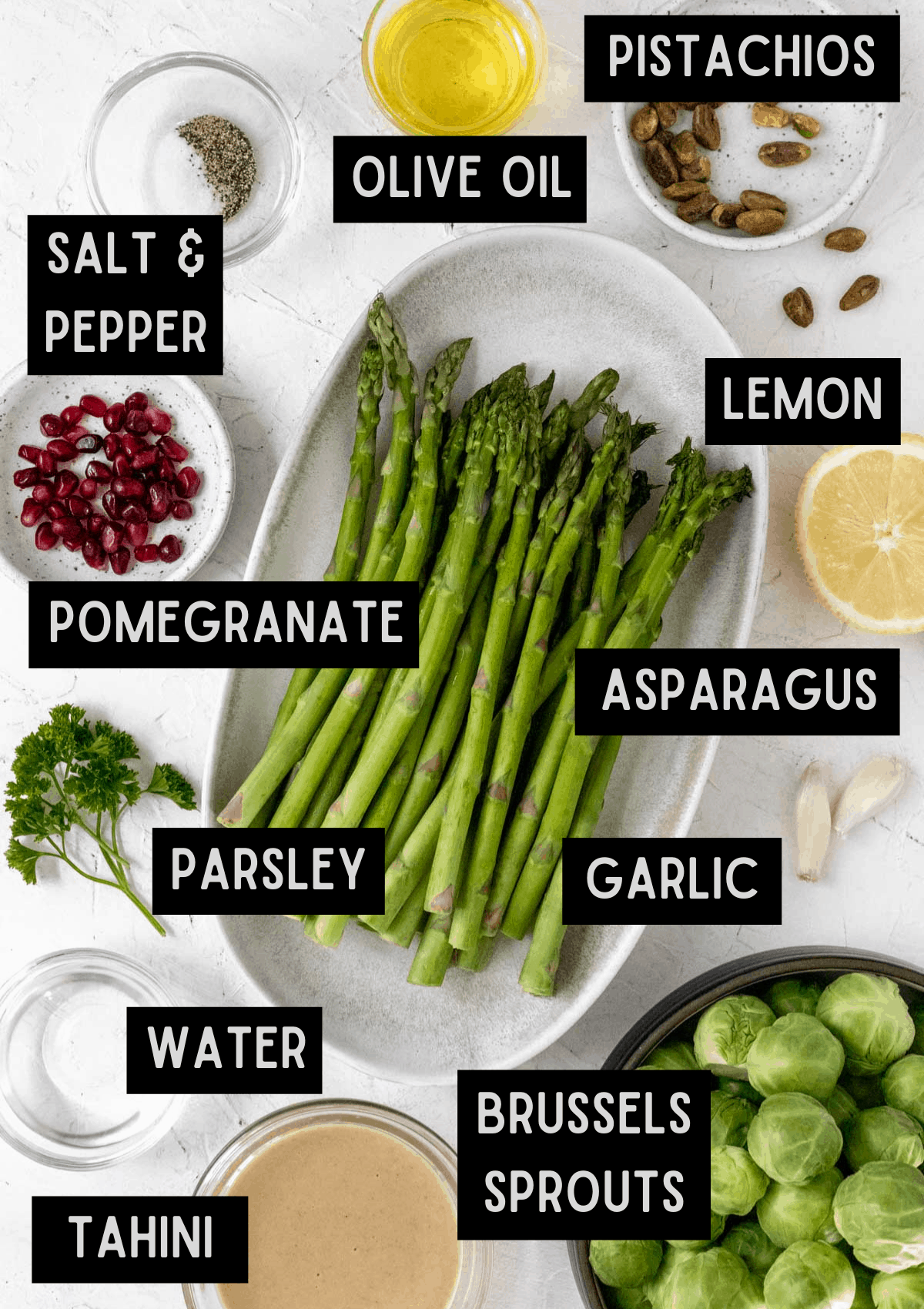 Labelled ingredients for roasted asparagus, brussels sprouts, and lemon tahini sauce (see recipe for details).