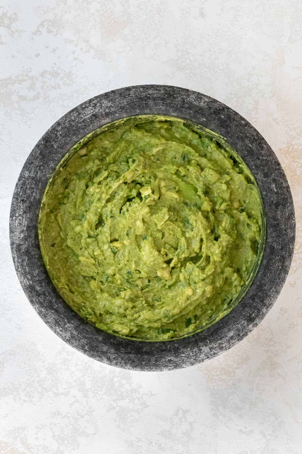 Homemade guacamole made with a pestle and mortar.