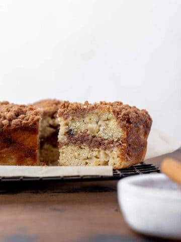 A slice of apple cider and date coffee cake with a swirl of cinnamon sugar in the middle.