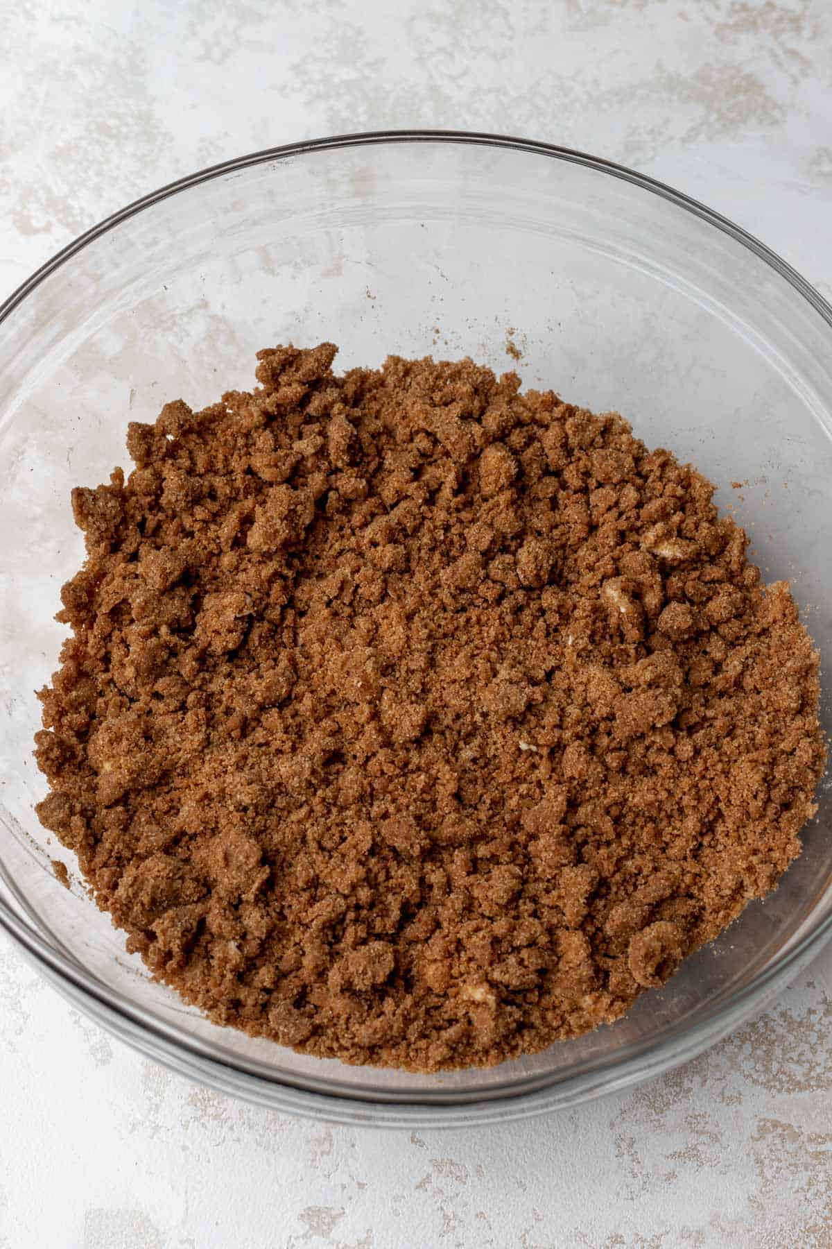 A cinnamon sugar streusel in a mixing bowl before baking.