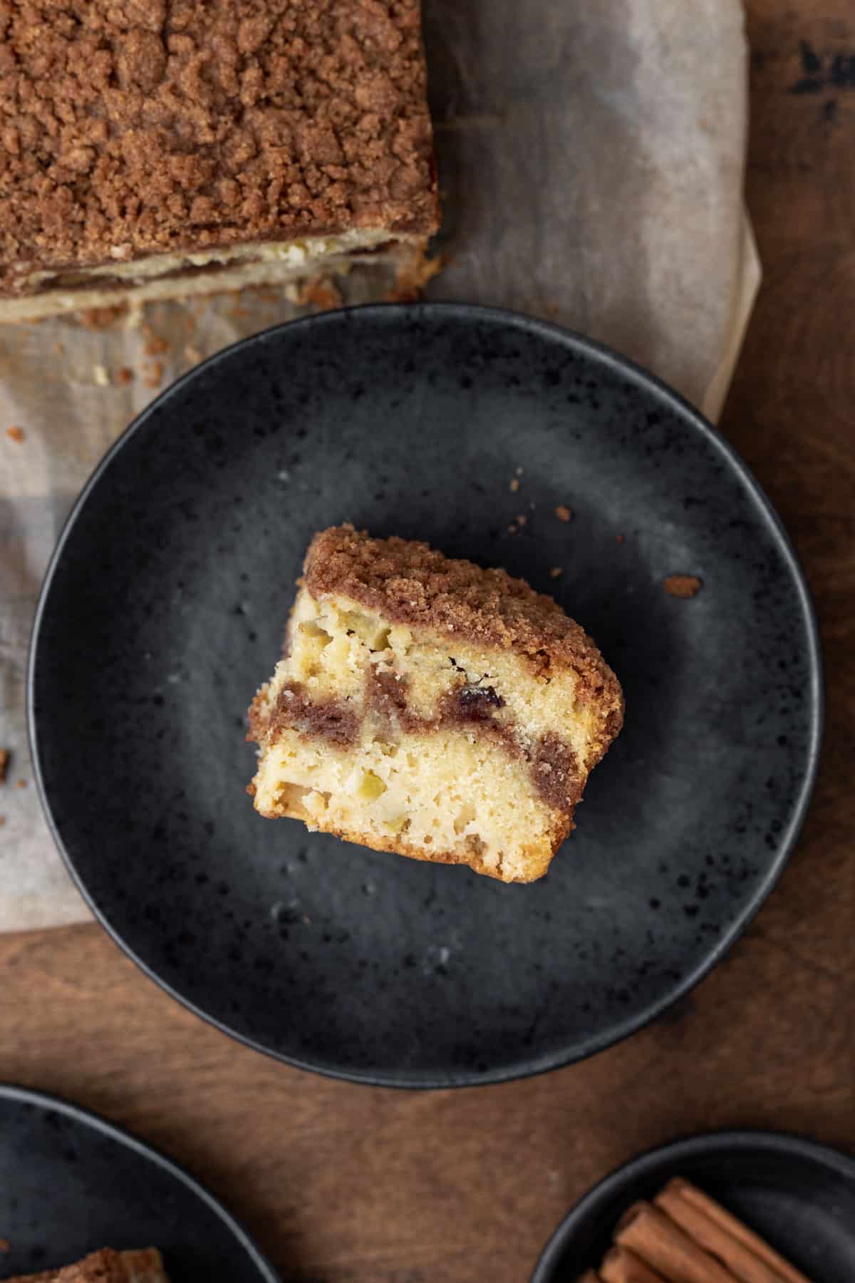 A closeup view of a slice of coffee cake showing the cinnamon sugar swirl in the middle.