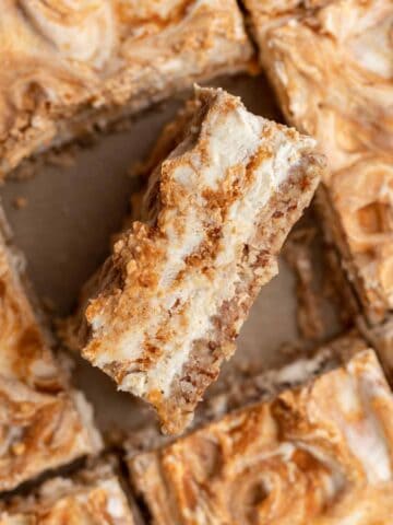 An inside view of a cheesecake bar so you can see the pumpkin swirl in the middle.